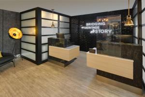 a dressing room with a bench and a mirror at The Insignia Hotel, Sarnia, a Tribute Portfolio Hotel in Sarnia