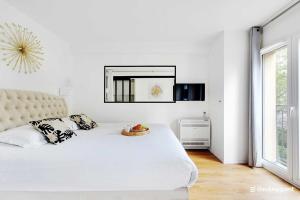 Ένα ή περισσότερα κρεβάτια σε δωμάτιο στο CMG Résidence Sacrée Coeur - Montmartre