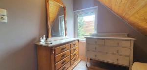 a bedroom with a dresser and a mirror at Apartment Balatonfenyves - Balaton 26709 in Balatonfenyves +28 photos