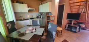a small kitchen with a table and a television at Apartment Balatonfenyves - Balaton 26709 in Balatonfenyves