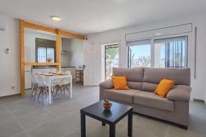a living room with a couch and a table at LEON INMO Apartment Dante - 15774 in Empuriabrava