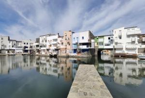 a group of buildings next to a river with houses at LEON INMO Apartment Dante - 15774 in Empuriabrava