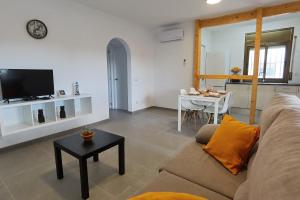 a living room with a couch and a table at LEON INMO Apartment Dante - 15774 in Empuriabrava