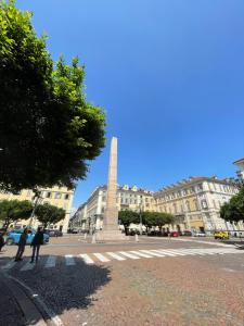 a monument in the middle of a city with buildings at Ai Savoia B&B - Guest House in Turin