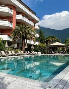 a swimming pool in front of a hotel at Palace Hotel Città in Arco