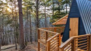 a cabin in the woods with a blue roof at Loblolly Pines Adventure Aframe #1 in Eureka Springs