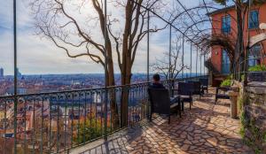 a man sitting on a chair looking out over a city at Hostel Lyon Centre in Lyon