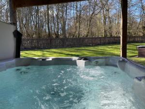 a jacuzzi tub in the backyard of a yard at Loch Lomond Luxury Lodges in Drymen