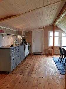 Il comprend une cuisine dotée de parquet et d'un plafond en bois. dans l'établissement Leilighet Vikaparken Hardangerfjord, à Hatlestrand