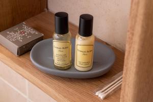 two bottles of essential oils sitting on a shelf at Hôtel de Lion sur Mer in Lion-sur-Mer