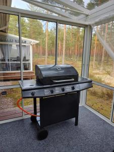 a grill sitting on a table in front of a window at Nicolas apartment in Loimaa
