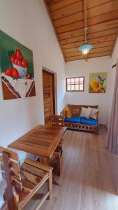 a living room with a wooden table and a couch at Villas Montelindo in Constanza