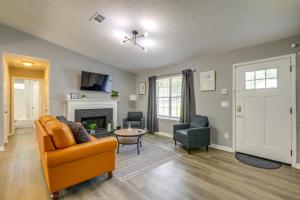 a living room with a couch and a fireplace at Decatur Vacation Rental with Fenced Yard! in Decatur