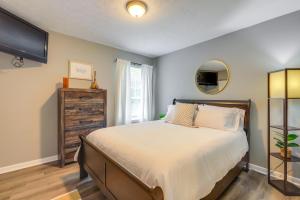 a bedroom with a large bed and a window at Decatur Vacation Rental with Fenced Yard! in Decatur