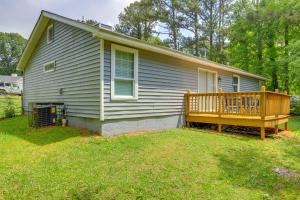 a small house with a porch and a deck at Decatur Vacation Rental with Fenced Yard! in Decatur
