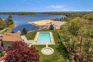 an aerial view of a swimming pool and a lake at Welcome to The Mountain Escape! in Albrightsville