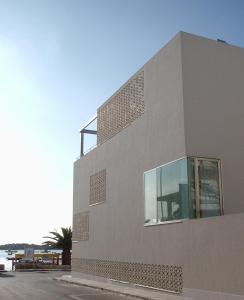 a building with a window on the side of it at Hotel Grecale in Porto Cesareo