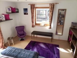 1 dormitorio con cama morada y ventana en Ferienwohnung Felix, en Neustift im Stubaital