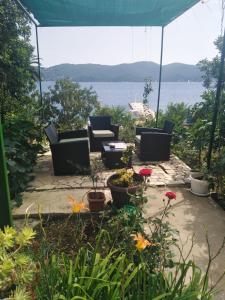 a patio with couches and a view of the water at Apartman Iva in Kučište