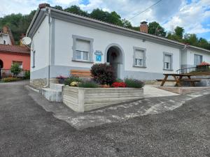 a white building with a bench in front of it at CASA AMABLE in La Roza