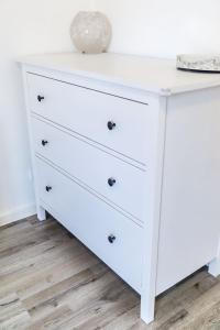 a white dresser with a white lamp on top of it at in Dattenberg in Dattenberg