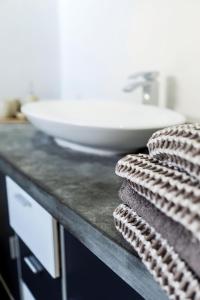 a bathroom counter with a sink and towels at in Dattenberg in Dattenberg