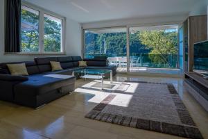 a living room with a couch and a glass table at The Glass House & SPA in Caslano