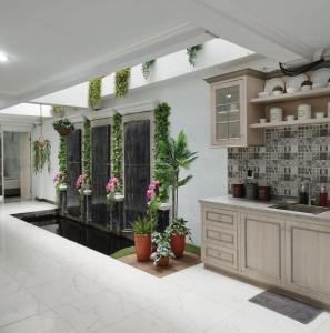a kitchen with a counter and some plants at Nest Residence in Jakarta