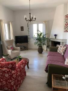 a living room with a couch and a chair at FYKIA HOUSE in Naousa