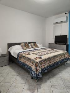 a bedroom with a bed and a television in it at Casa Josè Suite Mare in Palermo