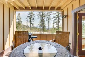 a dining room with a glass table and chairs at Ski-InandSki-Out Whitefish Duplex with Hot Tub! in Whitefish