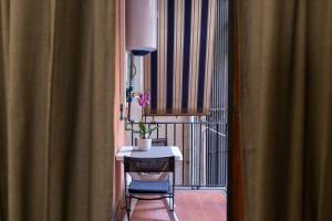 a room with a table and a chair and a window at Dulcis In Colosseo Apartments in Rome