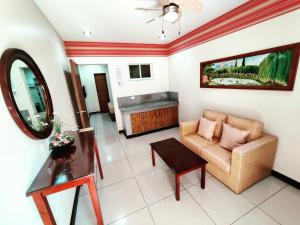 a living room with a couch and a table at Executive Tulip Apartelle in Davao City