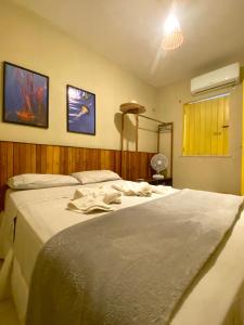 ein Schlafzimmer mit zwei Betten mit weißer Bettwäsche in der Unterkunft Chalés Amarante in Fortim