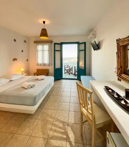 a bedroom with a bed and a view of the ocean at Horizon Hotel in Chora Folegandros