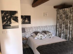 a bed with two pillows on it in a bedroom at L' îlot des îles in Cuxac-dʼAude