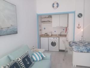 a living room with a couch and a kitchen at stella di mare in Rapallo