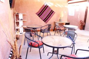 a group of tables and chairs in a room at Casa Sirius in San Pedro de Atacama