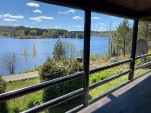 a view of a lake from a house window at Lakefront Cabin in Magnor