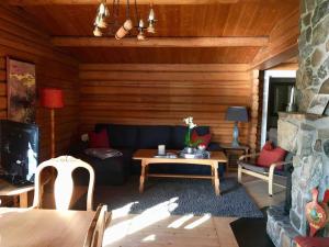 a living room with a couch and a table at Lakefront Cabin in Magnor