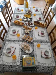 a long table with food on it with a table cloth at Chez Sally et Mario in Arnage