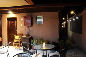 a patio with a table and chairs and a candle at Casa Sirius in San Pedro de Atacama