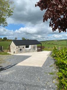 a stone house with a black roof at The Hen House 