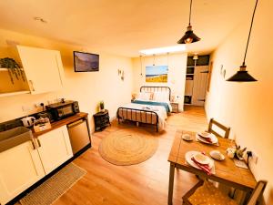 a living room with a bed and a table at Norfolk Farm Stays by Beach Dog Friendly in Heacham