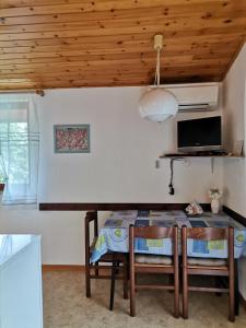 a dining room with a table and chairs at Apartment Studio Zvonka in Zambratija