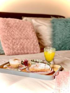 a tray with food and drinks on a bed at Salaš kod Bobana in Bač