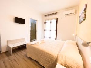 Postel nebo postele na pokoji v ubytování B&B BABBU MEU