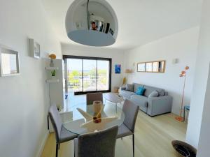 a living room with a table and a couch at La Rade in Cassis