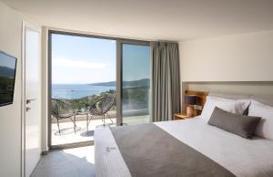 una camera con letto e vista sull'oceano di Exclusive Villas Pappas a Sárti