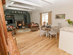 a kitchen and living room with a table and chairs at Gilly Skyber in Helston